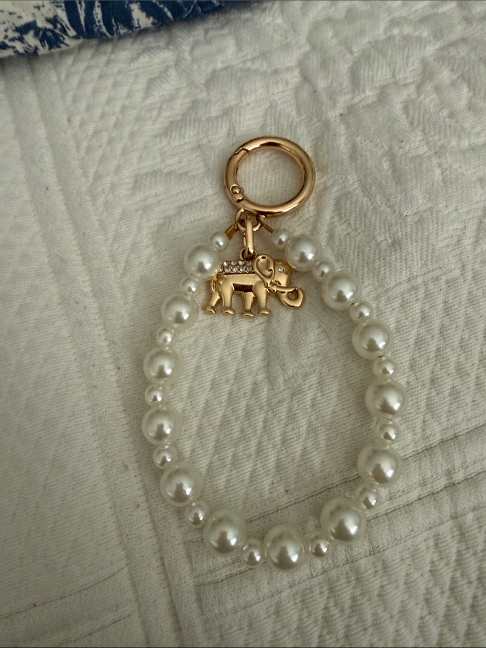 Gold Elephant and Pearl bag charm is unbranded the elephant is Chicos charm